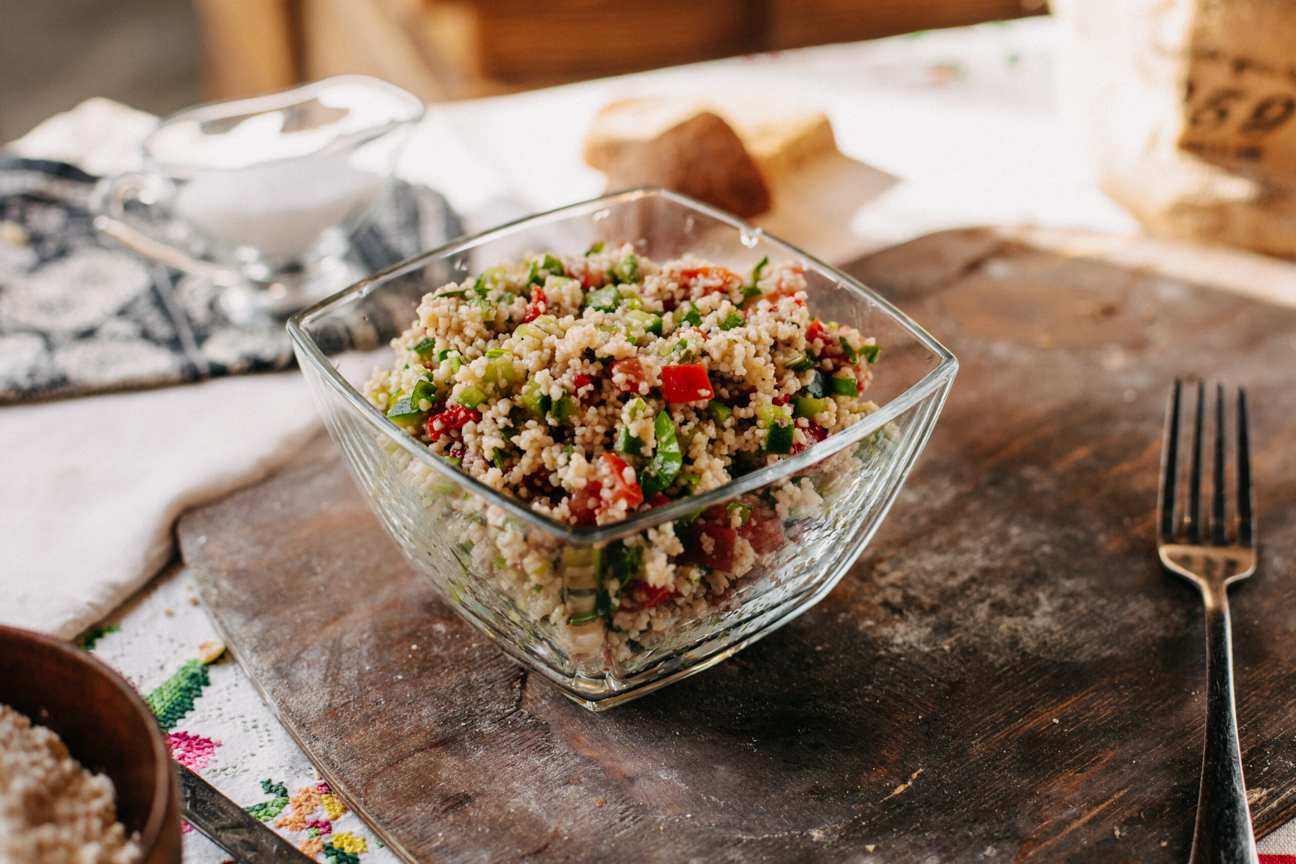 Tigela de tabule de cuscuz marroquino com grão-de-bico, pimentão e pepino.